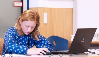 a girl is programing her own game