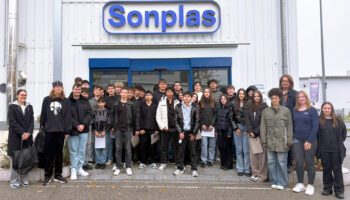 pictured are the students with their teachers standing infront of a Sonplas building