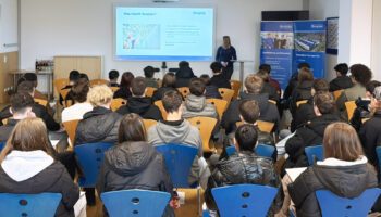 pictured are the students sitting in the meeting room while they are listening to the presentation of the business portfolio